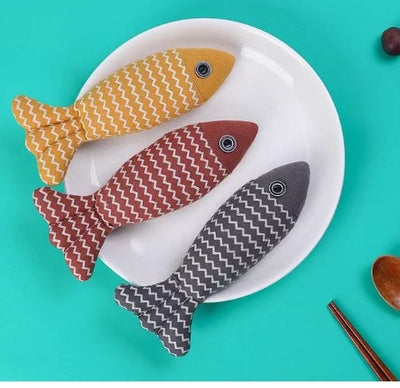 Yellow linen fish cat toy with white zigzag pattern and black and white eye detail on a white background. - Image 6