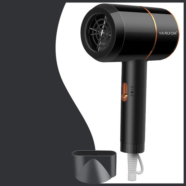 White portable folding hair dryer with rose gold accents and a nozzle attachment, shown with its base.