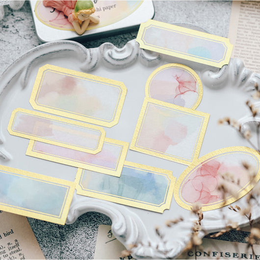 Assorted decorative paper labels with gold foil borders and soft watercolor designs in pink, blue, and green hues. - Image 2