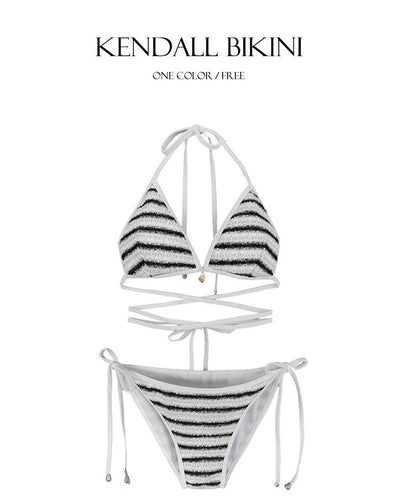 White and black striped bikini with triangle-cut top and tie-side bottom, modeled outdoors. - Image 23