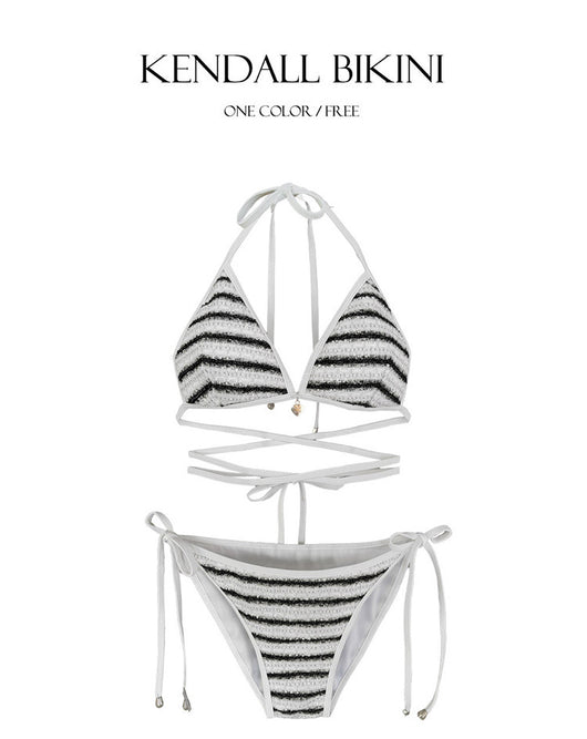 White and black striped bikini with triangle-cut top and tie-side bottom, modeled outdoors. - Image 23