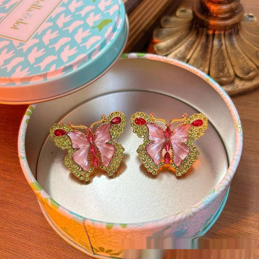 Pink enamel butterfly brooch with green, red, and clear rhinestones set in gold-toned metal. - Image 5
