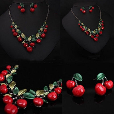 Cherry necklace and earring set featuring red enamel cherries and green leaves on a dark chain, displayed on a black bust. - Image 8