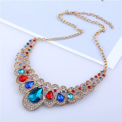 Gold-tone necklace and matching drop earrings set with clear teardrop gems and sparkling rhinestones. - Image 11