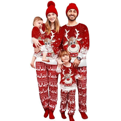 Family of four wearing matching red Christmas pajamas with reindeer and snowflake patterns and red pom-pom beanies. - Image 15