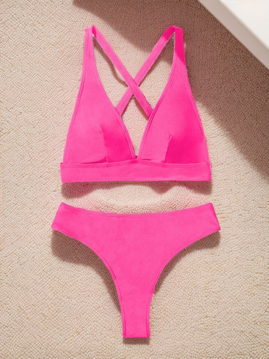 Bright blue two-piece bikini with a V-neck halter top and high-cut bottoms on a woman at the beach. - Image 21