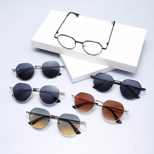 Round metal sunglasses with silver frames and dark gray lenses, featuring black temple tips, on a white background.