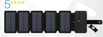Black portable folding solar panel charger with six panels attached to a backpack in an outdoor setting. - Image 4