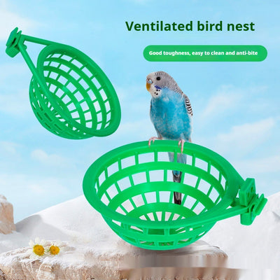 Green plastic bird nest with a grid design and an attached clip, measuring approximately 17.5cm wide.