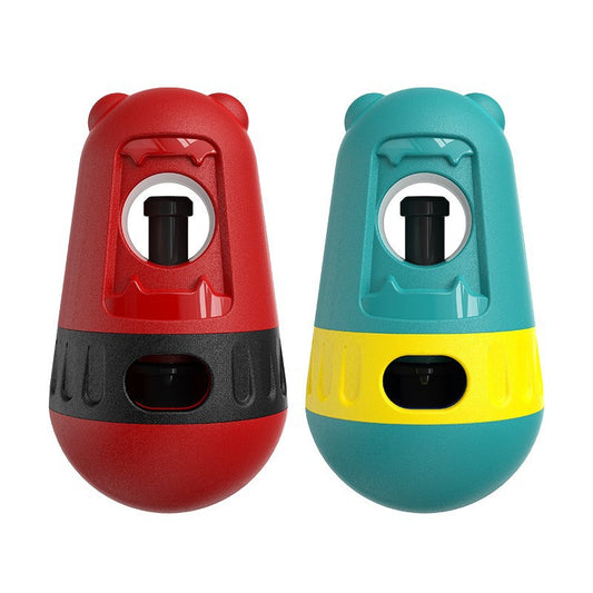 Red and black slow feeder dog toy with a treat dispenser, next to a bulldog playing with a green and yellow version. - Image 2