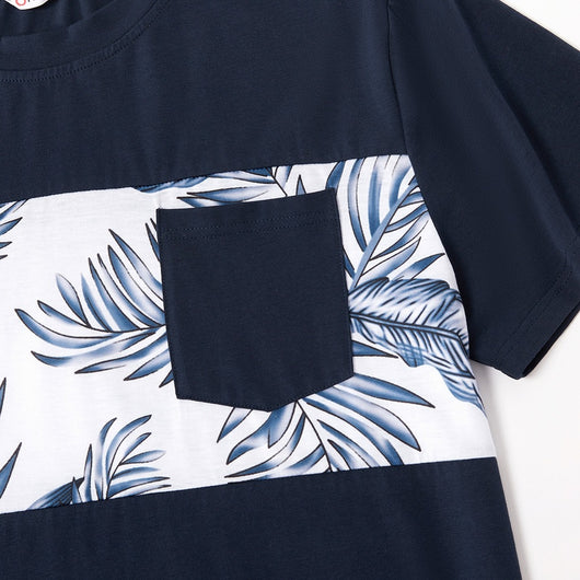 Young boy wearing a white short-sleeve t-shirt with blue tropical leaf print and a black chest pocket. - Image 27