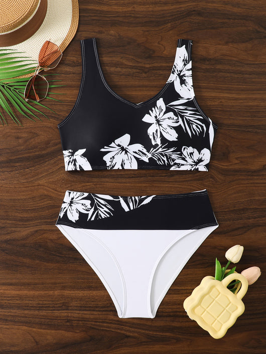 Women's two-piece swimsuit with black and purple floral print. Features a V-neck sports bra top and mid-rise bottom. - Image 26