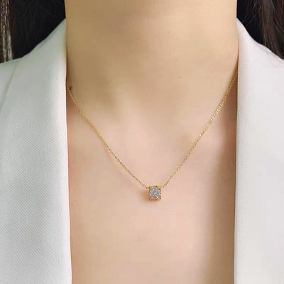Delicate silver-colored chain necklace with a single square-cut clear stone pendant in a four-prong setting on a woman's neck. - Image 12