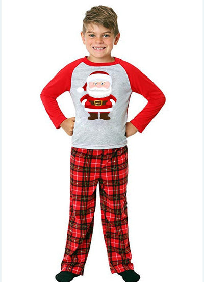 Young boy wearing a Christmas pajama set with a grey Santa Claus raglan shirt and red plaid pants. - Image 10