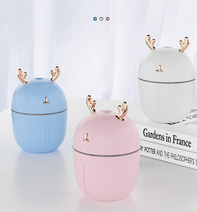Pink deer-shaped mini humidifier with gold antlers and a glowing blue light band, on a pink background. - Image 7