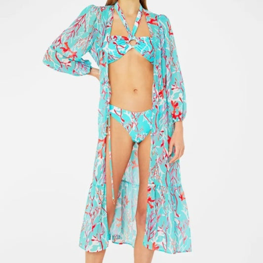 Women's light blue bikini with red coral print, featuring a halter top, high-cut bottom, and matching sarong.