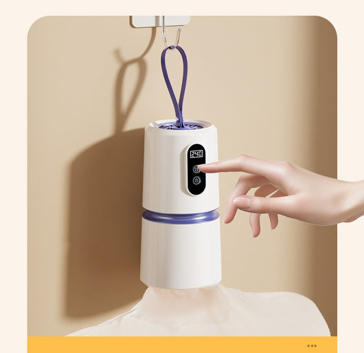 White and blue mini household air dryer with a digital display and hanging loop, shown next to a gold smartphone. - Image 15