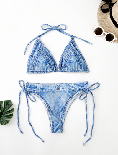 Women's light blue denim print two-piece bikini swimsuit with a halter neck top and tie-side bottoms, styled with a straw hat and sunglasses. - Image 8