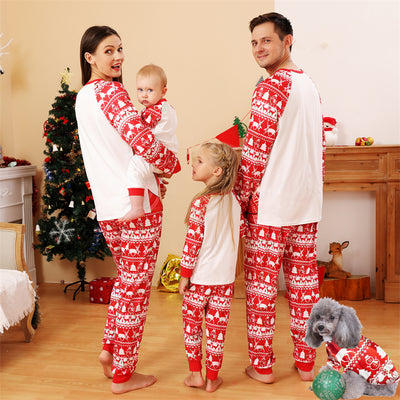 Baby wearing a red and white Christmas pajama set with a fawn graphic, sitting on a white blanket. - Image 9
