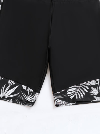 Women's black and white tropical leaf print short sleeve rash guard top with a quarter-zip, paired with solid black swim shorts featuring matching printed cuffs - Image 13