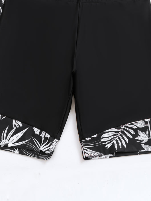 Women's black and white tropical leaf print short sleeve rash guard top with a quarter-zip, paired with solid black swim shorts featuring matching printed cuffs - Image 13