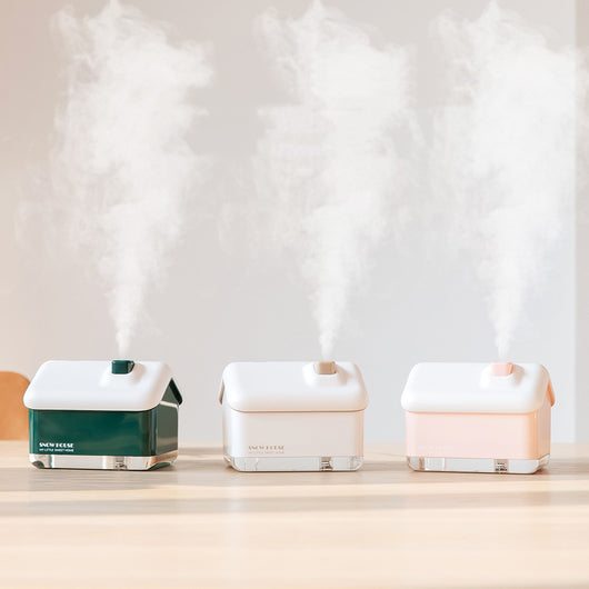 Pink and white house-shaped mini air humidifier with a clear base, a white roof, and a USB cable. - Image 7