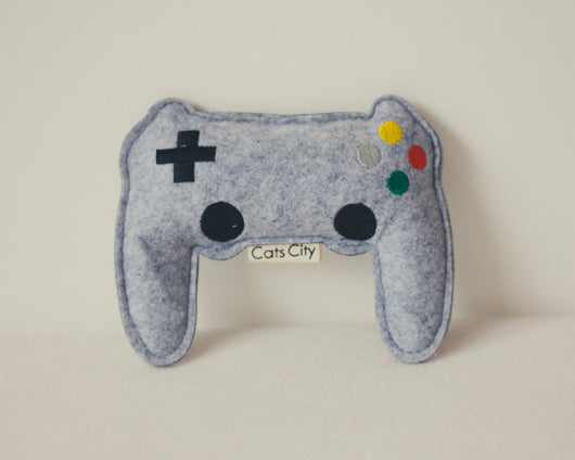 Light blue felt catnip toy shaped like a game controller with piano keys and a black string for hanging. - Image 15