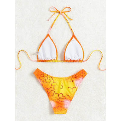 Yellow and orange floral string bikini swimsuit for women, featuring a triangle top and high-cut bottoms by a pool. - Image 4