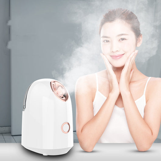 White and rose gold steam facial sprayer emitting warm mist, shown on a light wooden table. - Image 10