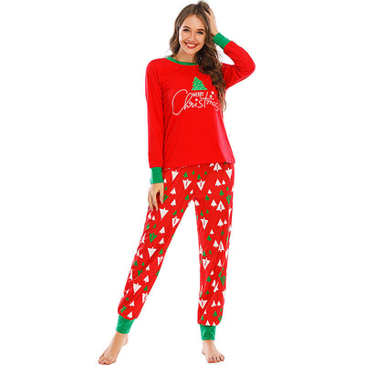 Family of five wearing matching red and navy blue Christmas pajamas with reindeer tops and fair isle pants. - Image 5