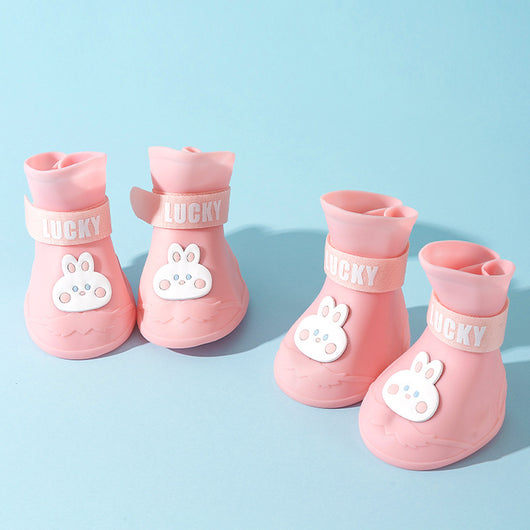 Four yellow silicone dog booties with a cartoon dog face emblem and "LUCKY" strap on a light blue background. - Image 7