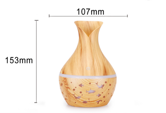 Dark wood grain humidifier shaped like a vase, with glowing green animal cutouts and mist emitting from the top. - Image 7