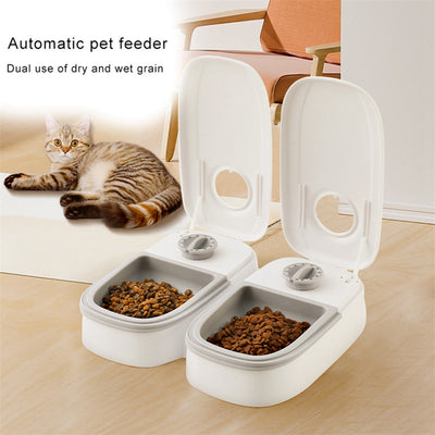 White automatic pet feeder with a pink timer dial and an embossed paw print on the lid. - Image 13
