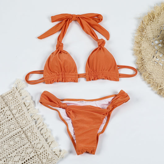 Orange pure color bikini with knotted halter top and banded thong bottoms, displayed flat on a white background. - Image 17