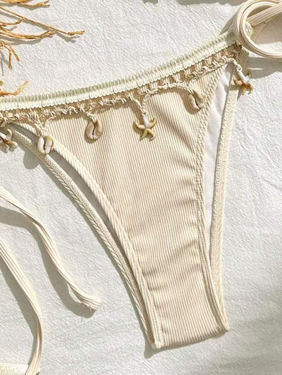 Light pink ribbed halterneck bikini with triangle cups and tie-side bottom, adorned with shell and starfish charms. - Image 16