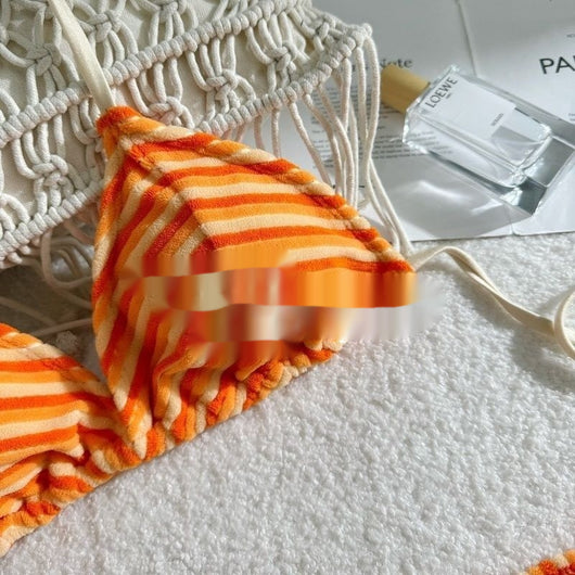 Orange and light orange striped bikini bottom with a ribbed texture and elastic waistband, ideal for beach vacations. - Image 5