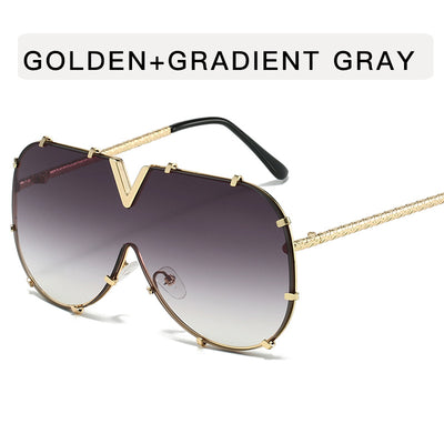 Oversized V-shaped sunglasses with a gold metal frame, white accents, clear lenses, and decorative rivets. - Image 10
