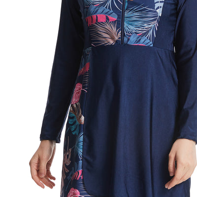 Woman in a navy blue quick-drying conservative swimwear set with a tropical leaf print tunic and matching swim cap. - Image 15