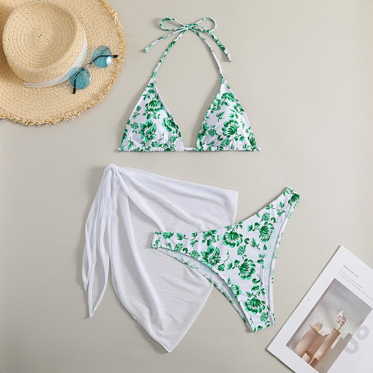 White and yellow floral print three-piece bikini set with a halter triangle top, high-cut bottom, and sheer white sarong. - Image 8