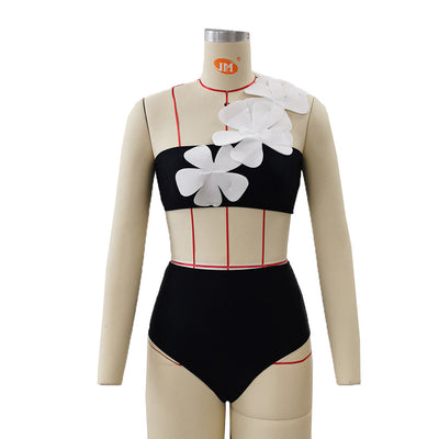 Women's black one-shoulder two-piece swimsuit with large white floral appliques and high-waisted bottoms. - Image 9