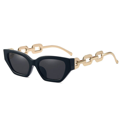 Red cat-eye sunglasses with dark lenses and gold-colored chain link temples on a white background. - Image 2