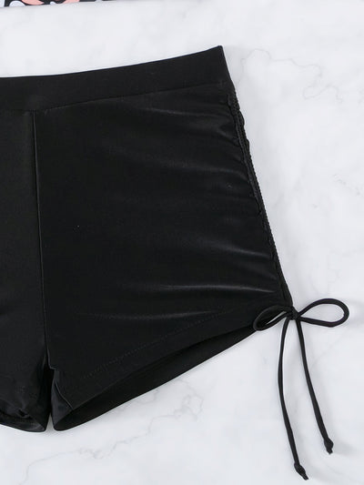 Women's two-piece swimsuit featuring a black halter crop top with pink and white floral print and solid black swim shorts. - Image 12
