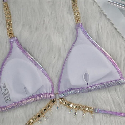 Iridescent purple and pink two-piece bikini with gold-toned crystal embellishments on a white faux fur background. - Image 31