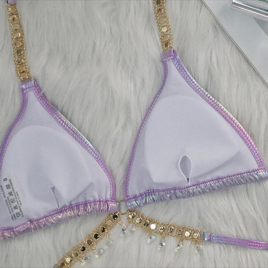 Iridescent purple and pink two-piece bikini with gold-toned crystal embellishments on a white faux fur background. - Image 31
