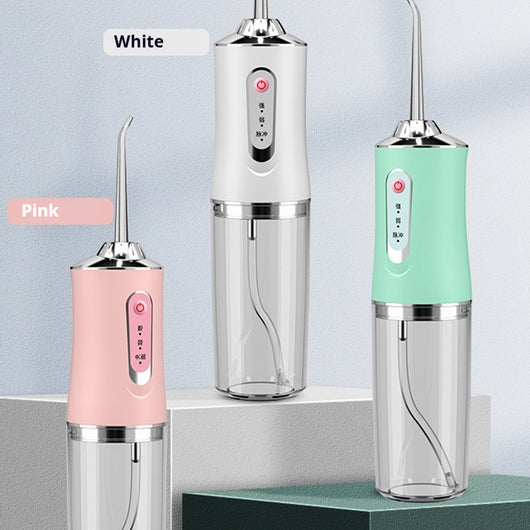 Pink portable electric oral irrigator with clear water tank and four nozzles, highlighting adjustable pressure and pulse mode. - Image 16