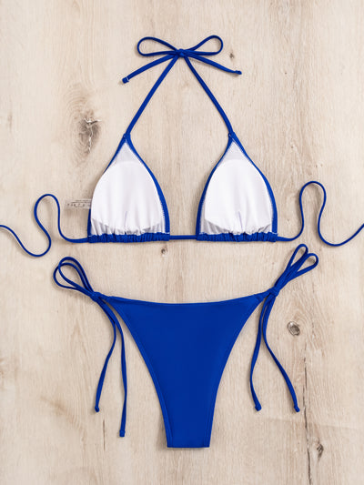 Neon yellow halter bikini with triangle top and tie-side bottoms, displayed on a light wood surface. - Image 46