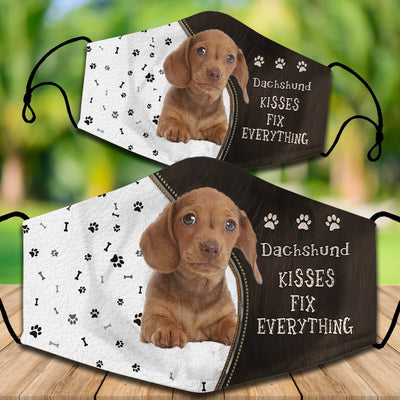 Two cotton face masks with a Bichon Frise dog, paw prints, and bones on a white and brown background. Text reads "Bichon Frise KISSES FIX EVERYTHING." - Image 29