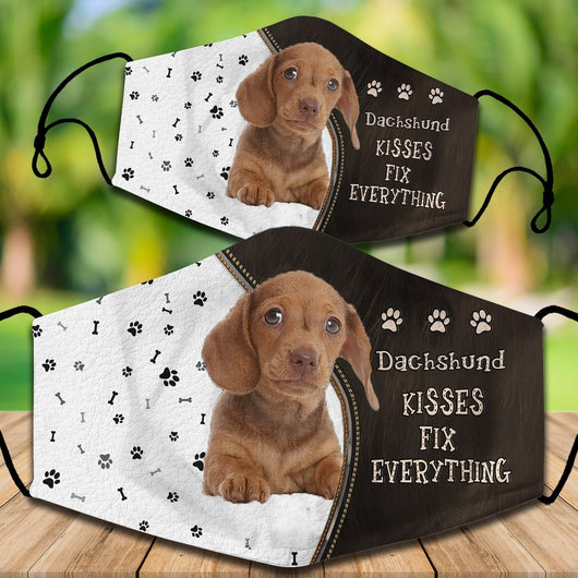Two cotton face masks with a Bichon Frise dog, paw prints, and bones on a white and brown background. Text reads "Bichon Frise KISSES FIX EVERYTHING." - Image 29