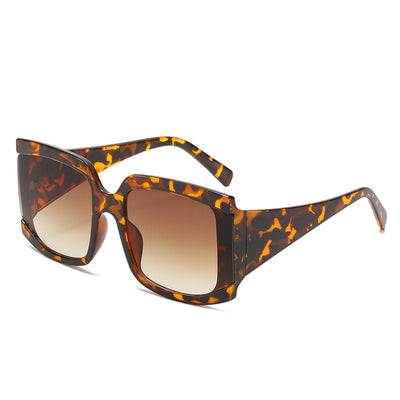 Oversized square-frame sunglasses with a light pink frame and gradient lenses transitioning from purple to orange to yellow. - Image 6