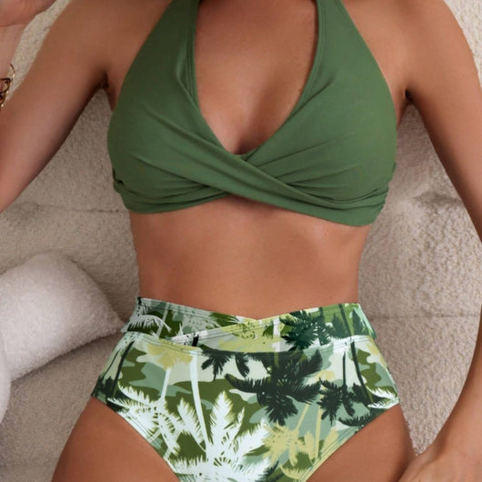 Women's green halter top swimsuit with twisted front and high-waisted bottoms featuring a green palm tree print.
